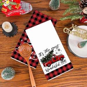 Christmas tea towels with red black buffalo plaid and vintage truck on a wooden background