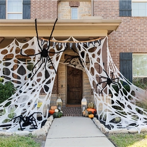Outdoor Halloween decor set with giant white web, black spiders and Trick or Treat banner