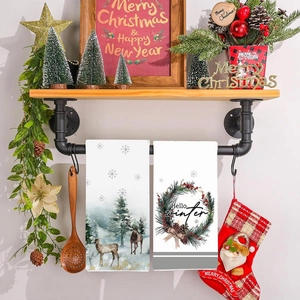 Two-pack Christmas hand towels featuring reindeer and pine cone wreath decor