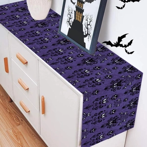 Purple Halloween table runner featuring spooky eye patterns and decorative scrolls