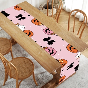 Pink Halloween table runner with cute pumpkins, ghosts and black cats for party decor