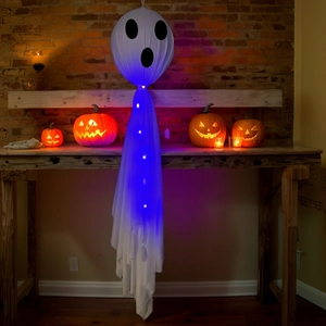 Detail of glowing white Halloween ghost hanging with blue LED lights and spooky face