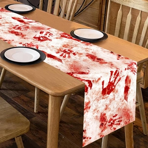 Halloween table runner featuring bloody handprints and splatters on a white background