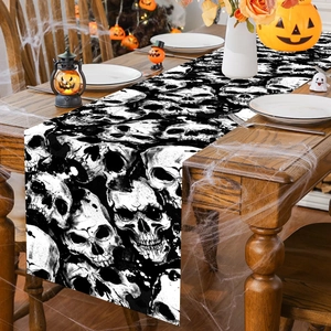 Halloween table runner with black and white skull patterns for gothic party dining decor