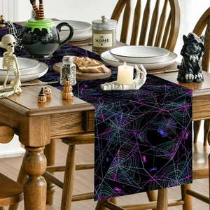 Black Halloween table runner with neon purple spider webs on dark wooden table