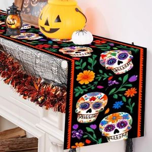 Halloween table runner featuring colorful sugar skulls and floral patterns with orange trim