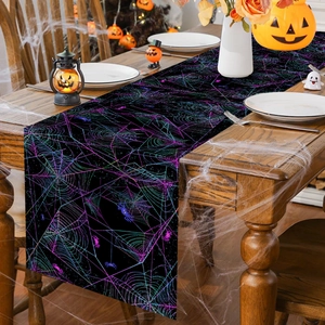 Detail of Halloween table runner with colorful spider web pattern on a wooden dining table