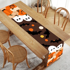 Halloween table runner with cute ghost and pumpkin prints on dark brown fabric background
