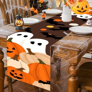 Halloween table runner featuring pumpkins and ghosts on a dark brown fabric