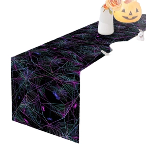 Colorful neon spider web Halloween table runner with pumpkins and festive party decorations
