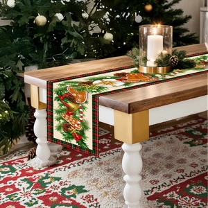 Christmas table runner with gingerbread man and pine motifs on a festive wooden dining table