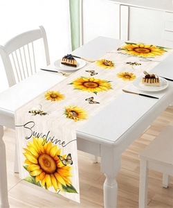 Detail view of sunflower and butterfly printed table runner on white wood background