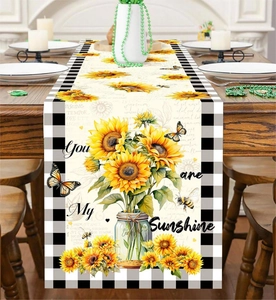 Detail of sunflower and butterfly table runner with black and white buffalo plaid edges