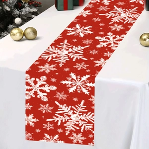 Christmas table runner with white snowflake pattern on red fabric for holiday decor