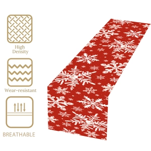 Detail of red Christmas table runner showing white snowflake pattern and durable fabric texture