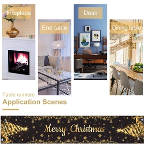 Detailed view of black Christmas table runner with golden reindeer and tree patterns
