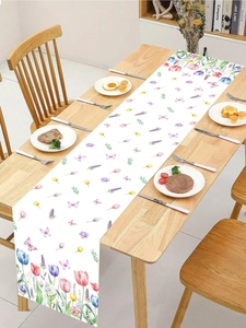 Detailed shot of white floral table runner with colorful tulips and lavender on wood table