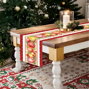 Detail of Christmas table runner with pine cone and colorful bauble prints on wood table