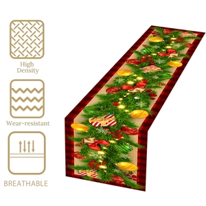Christmas table runner with red black plaid edges, bells and light string patterns