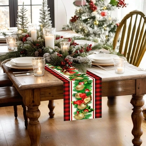 Detail of polyester Christmas table runner with red plaid edges and festive ball prints