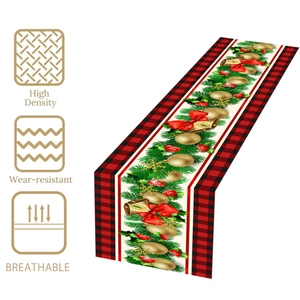 Christmas table runner with red black plaid pattern and festive bell ornaments decoration