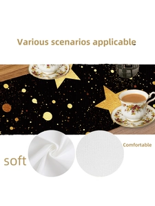 Detail of soft white Christmas table runner with gold star patterns and fabric texture