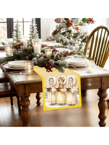 Detailed view of yellow Christmas table runner featuring singing girls on a wooden table