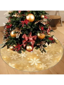 Macro shot of gold Christmas tree skirt with intricate white snowflake patterns