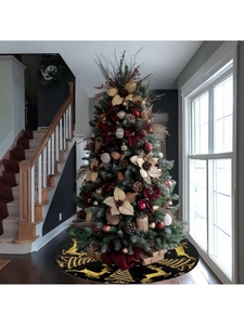 Close-up of black Christmas tree skirt featuring golden reindeer and snowflake patterns