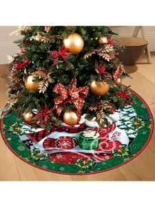 Close-up of Christmas tree skirt featuring snowman, cocoa cup and golden bow detail