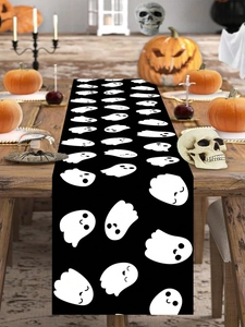 Detailed view of Halloween ghost table runner on a dining table with spooky decor