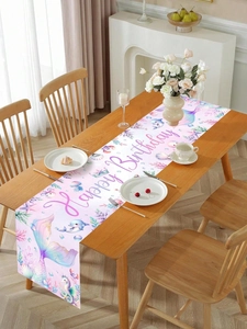 Detailed view of the mermaid-themed birthday table runner on a light wooden table