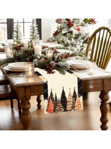 Close-up detail of Christmas table runner featuring colorful tree patterns on linen fabric