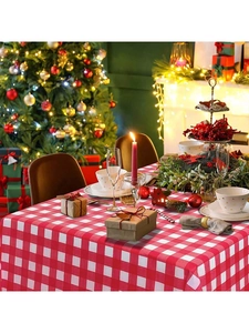 Detail of red and white checkered tablecloth in a festive Christmas dining setting