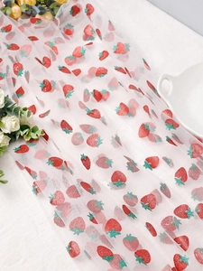 Detail of white mesh fabric with red glitter strawberry patterns for DIY party decor