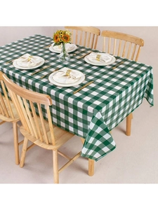 Detail of green and white checkered tablecloth texture on a wooden dining table