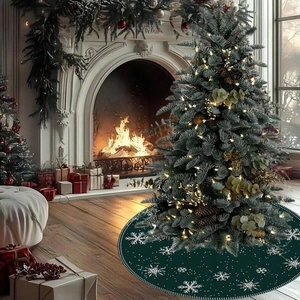 Dark green Christmas tree skirt with white snowflake patterns in a cozy holiday living room