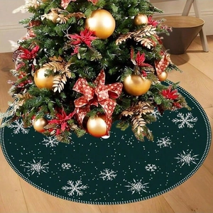 Dark green Christmas tree skirt featuring white snowflake patterns on a wooden floor