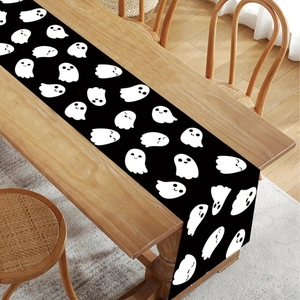 Cute white ghost table runner on wooden table for Halloween and Christmas decor