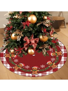 Detail of red Christmas tree skirt with plaid edges, gingerbread men, and snowflakes