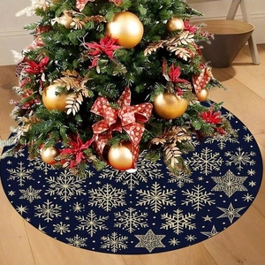Navy blue Christmas tree skirt with gold snowflake patterns on a rustic wooden floor