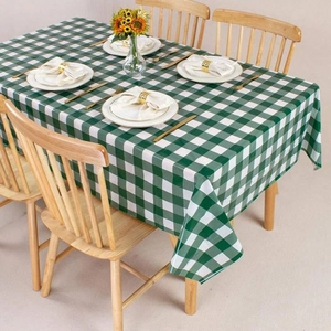 Classic green and white checkered tablecloth on a wooden table for home dining