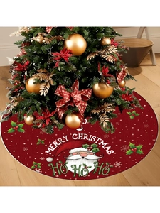 Detail of red Christmas tree skirt showing Santa Claus pattern and Merry Christmas text