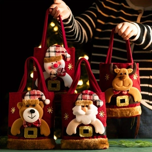 Detailed view of four Christmas gift bags with plush faux fur trim and 3D cartoon appliques
