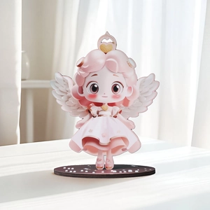 Cute pink wooden angel girl figurine with white wings on a dark round base