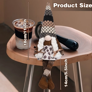 Close-up of coffee gnome plush doll featuring long dangling legs and a knitted hat