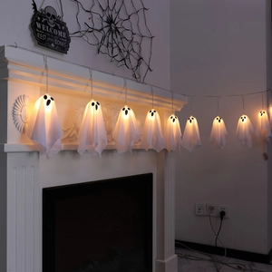Detail of glowing Halloween ghost string lights with warm LED on a fireplace mantel