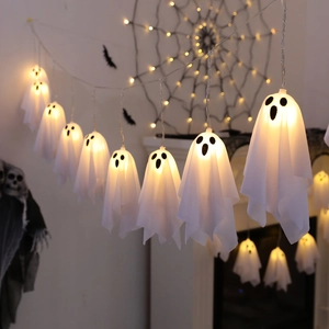 Close-up of warm yellow LED ghost string lights with various spooky face expressions