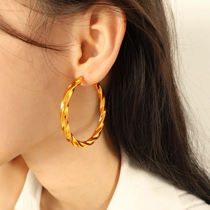 Fashionable oversized gold twisted hoop earrings made of durable stainless steel for women
