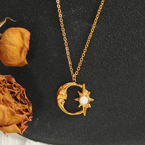 Collar con colgante de sol y luna dorada con piedra de ópalo blanco sobre fondo negro